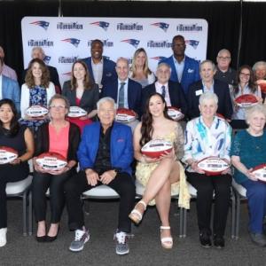 Patriots Chairman and CEO Robert Kraft, Patriots Executive Director of Community Affairs Andre Tippett and Procter & Gamble’s VP of Communications & Community Affairs, Global Grooming, Kara Buckley take a group photo with the 2025 Myra Kraft Community MVP Award winners at Gillette Stadium. (Photo courtesy Eric J. Adler/New England Patriots)