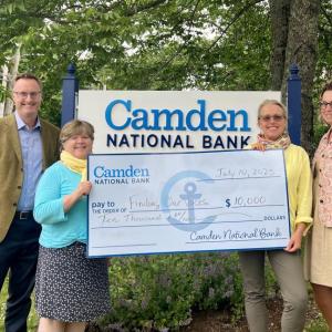 Simon Griffiths, CEO of Camden National Bank, with, left to right, Finding Our Voices Board Member Elizabeth True; Patrisha McLean, the nonprofit's CEO and founder; and Tina Flewelling, manager of the Blue Hill branch of Camden National Bank. (Photo courtesy Finding Our Voices)