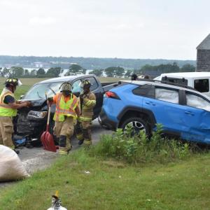 A dark colored pickup truck and a blue colored passenger car were involved in a crash Tuesday, July 1, on St. George Road at the entrance to Westbrook Street. In this picture, items are being put into another vehicle that was not involved in the incident. (Photo by Sarah Thompson)