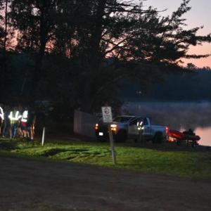 As the Union rescue boat is pulled from the water, Union firefighters confirm their plan to hand over all operations to the Maine Warden Service as the search continues for an overdue paddle boarder. (Photo by Sarah Thompson)