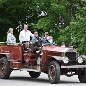 Chief Keller arrives in style with this chauffeur from the Town Office down the road. (Photo by Sarah Thompson)