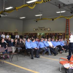 A wider angle of the Hope Corner Fire Station. More guests lined the wall along the left side of this picture. Members of the Hope Volunteer Fire Dept. (Photo by Sarah Thompson)