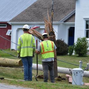 The bottom portion of a snapped utility pole is pulled from the ground following a single-vehicle crash on Hathorne Point Road, July 22, 2025. (Photo by Sarah Thompson)