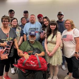 Danny Swindler's family welcomes him home. (l-r) Vicki Swindler, Logan Bailey, Avery Bailey, Dawn Bailey, Jason Bailey, Danny Swindler, II (blue shirt), Danny Swindler (green shirt, seated), Drew Swindler, Dylann Swindler, Daisy Swindler, Lucas Dube, and Julie Swindler. (Photo courtesy Dawn Bailey)