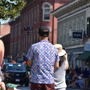 Spectators of the Maine Lobster Festival "Big Parade" come prepared to capture lasting memories Aug. 2, 2025. (Photo by Sarah Thompson)