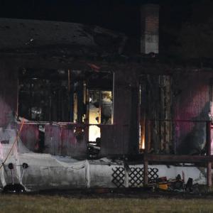 Flames that were initially only visible at two rear walls of 27 Westbrook Street quickly spread through the rest of the house, Saturday, Aug. 23, 2025. (Photo by Sarah Thompson)