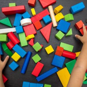 hands playing with blocks