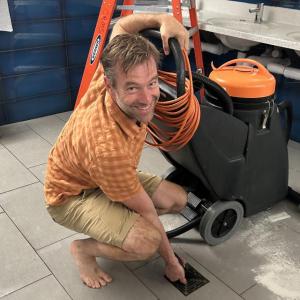 CRMS Principal Jacob Giessman rolls up his sleeves to help with the cleanup. (Photo courtesy SAD 28) c