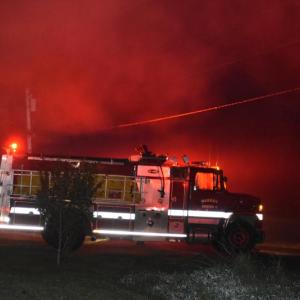 White smoke around the truck's red lights creates a red glow around the vehicle. (Photo by Sarah Thompson)