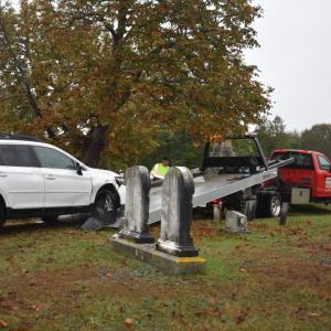 damaged car being pulled onto flatbed truck