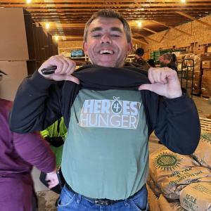 Volunteer shows off his Heroes 4 Hunger T-shirt