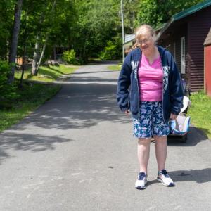 (Now) In June, Kristin Selwood of Winthrop, smiled as she posed for a photo at Pine Tree Camp to recreate a cherished image from her youth when she first came to camp. (Photo courtesy Pine Tree Camp)