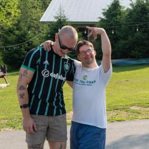 (Now) This summer, Gareth Robinson of Auburn (L) and Michael Thibodeau of Woolwich (R) recreated a favorite childhood photo of themselves at Pine Tree Camp. (Photo courtesy Pine Tree Camp)