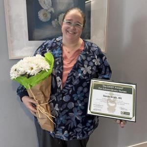 Sarah Smith, RN, with her DAISY Award. (Photo courtesy MaineHealth Pen Bay Hospital)