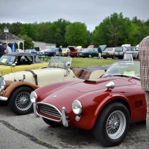 Vintage cars in a line with an observer in the foreground