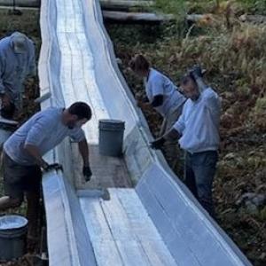 Abe Rhode, Kristi Van Blarcom, Ian Bogey, David Garner paint the toboggan chute with a fresh coat of white paint Oct. 5. (Photo courtesy Peter Berke)