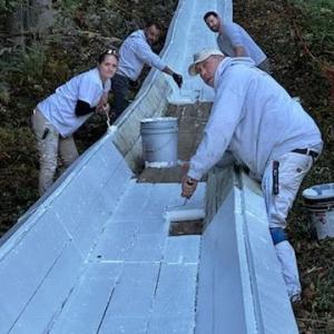 Abe Rhode, Kristi Van Blarcom, Ian Bogey, David Garner paint the toboggan chute with a fresh coat of white paint Oct. 5. (Photo courtesy Peter Berke)