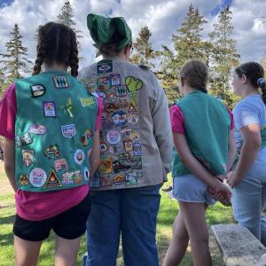 Many badges fill the backs of Girl Scout vests