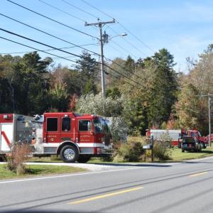 Fire trucks wait to be released from a shed fire