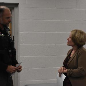 Patrol Officer Chris Hansen converses with Town Manager Kara George.  (Photo by Sarah Thompson)