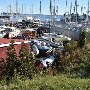 Vehicle on its side at the foreground of a boatyard