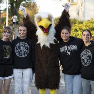 (Photo courtesy Hilary Petersen) Four teenage girls pose with Eddie, the mascot