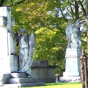 Two angel sculptures in Grove Cemetery