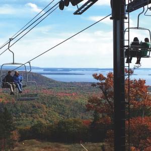 Riding the chairlift at the Camden Snow Bow up Ragged Mountain in Camden, with Penobscot Bay in the background. (Photo courtesy Camden Snow Bowl) Riding the chairlift at the Camden Snow Bow up Ragged Mountain in Camden, with Penobscot Bay in the background. (Photo courtesy Camden Snow Bowl)