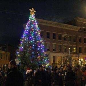 Illuminated Christmas tree with crowd around it