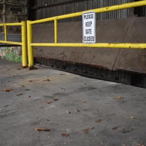Tire marks and a sign that reads "Please keep gate closed"