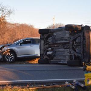 Two vehicles, one on its side