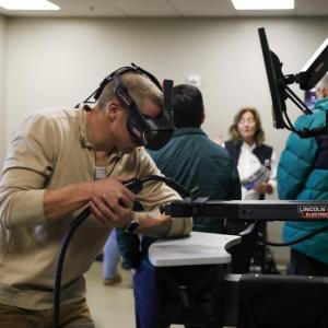 A man operates a piece of machinery