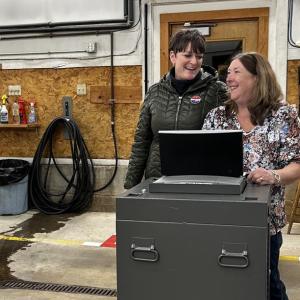 Camden Finance Director Jodi Hanson surprises Camden Town Clerk Katrina Oakes with a collective tribute Nov. 4, the last election that Oakes will oversee as Camden Town Clerk. (Photo by Lynda Clancy)