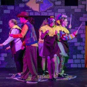 Four people act out a scene