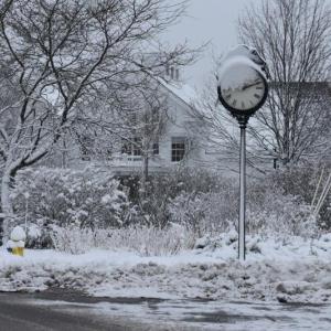 Snow covered pocket park with clock