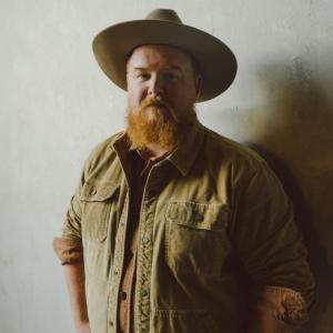 Man wearing tan hat, tan shirt
