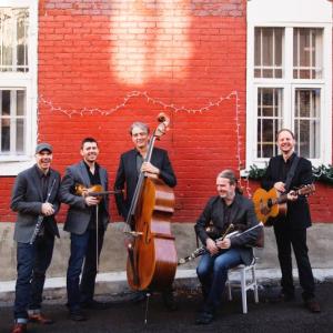 Lunasa in front of red brick building