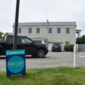 Police station parking lot with for sale sign