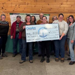 Group photo of an awardee and her oversized presentation check