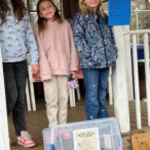 three girls and a bin of toys