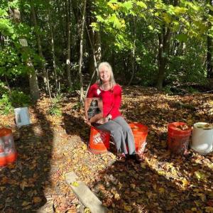Woman sitting on a bucket
