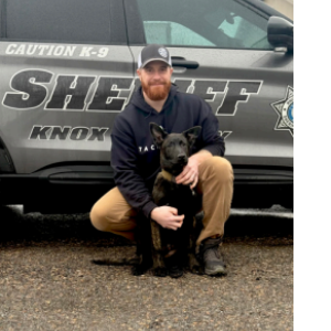 Man and dog pose in front of K9 cruiser