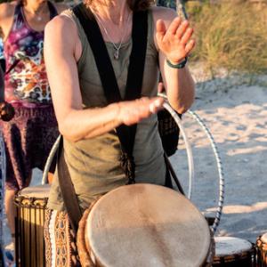 woman banging hand drum