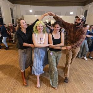 Four people dance together