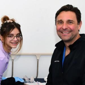 Young girl and doctor smile for the camera