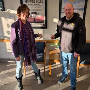 Woman and man pose with regular size check