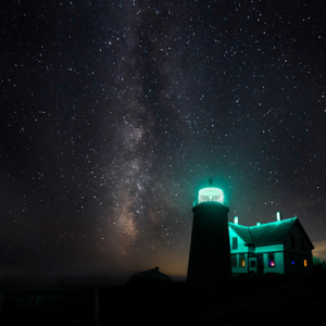 Celestial sky and illuminated lighthouse