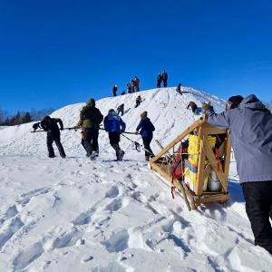 hauling provisions up a snow hill