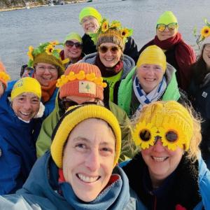 Group of women pose in selfie with yellow in their hats