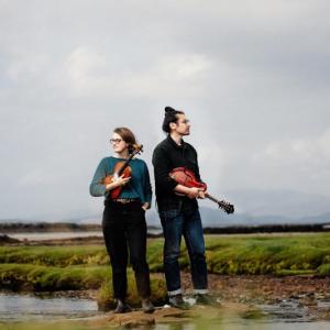 Two musicians standing in a marsh
